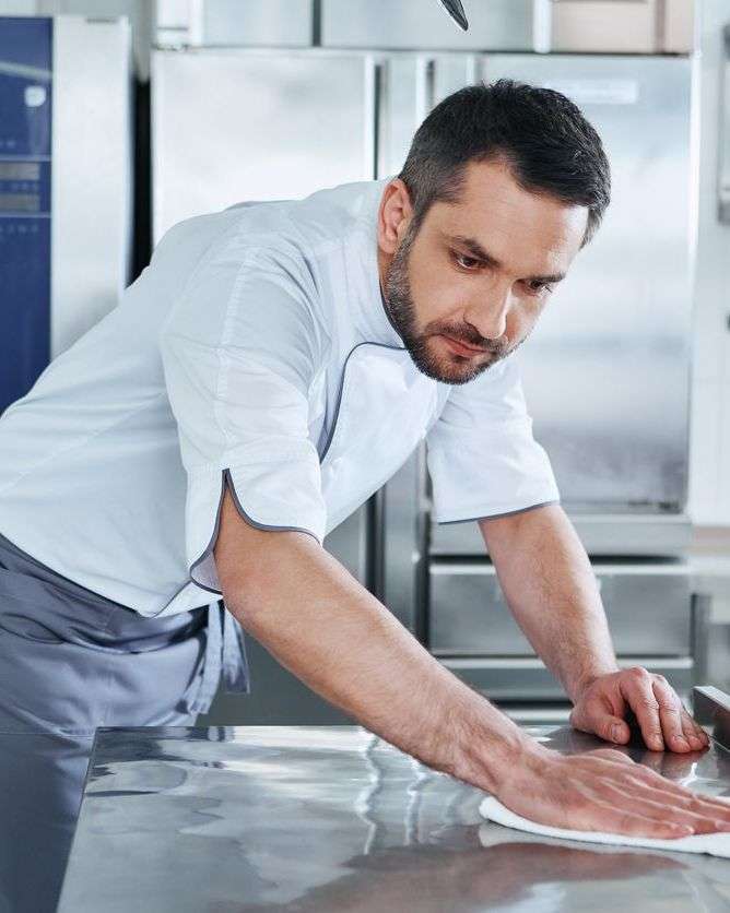 a man cleaning table
